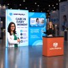 10x10 Backlit Tension Fabric Trade Show Booth with Dual-Height Rectangular Walls and TV Mount